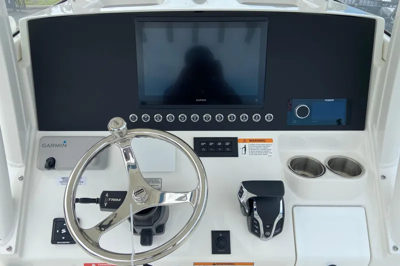 Slide: The Image of 2027 Regulator 26XO boat dashboard with Garmin display and steering wheel. - 25