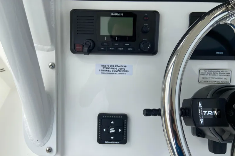 Slide: The Image of Control panel of 2027 Regulator 26XO boat featuring Garmin device and steering wheel. - 28