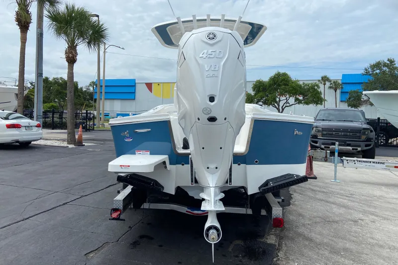 Slide: The Image of 2027 Regulator 26XO boat with Yamaha 450 V8 engine, parked outdoors. - 3