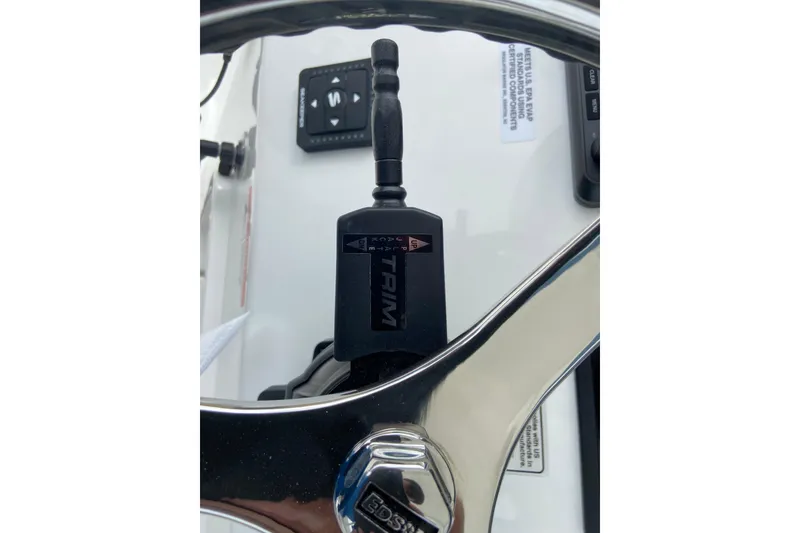 Slide: The Image of Close-up of 2027 Regulator 26XO boat steering wheel and trim control. - 30