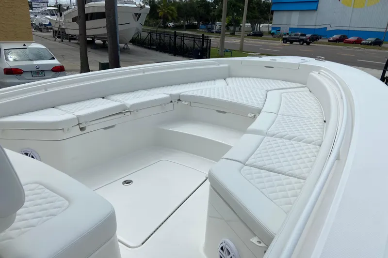 Slide: The Image of 2027 Regulator 26XO boat with spacious white seating and quilted cushions. - 34