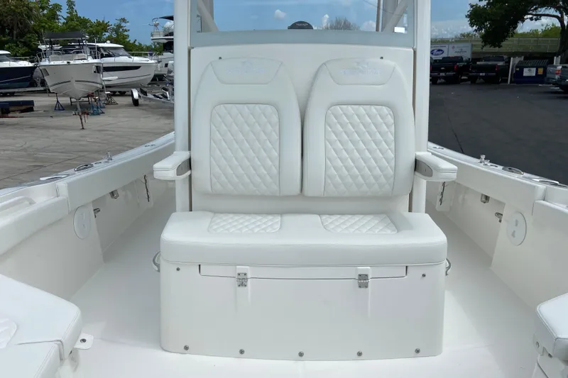 Slide: The Image of 2027 Regulator 26XO boat with white cushioned seating and sleek design. - 36