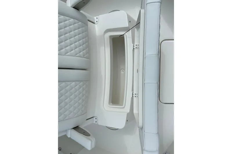 Slide: The Image of 2027 Regulator 26XO boat interior with quilted seating and storage compartment. - 37