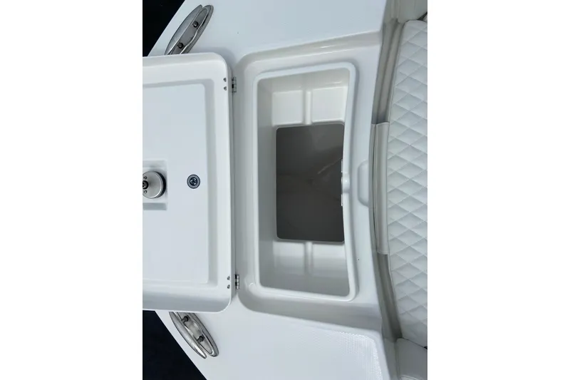 Slide: The Image of 2027 Regulator 26XO boat storage compartment with quilted seating detail. - 39