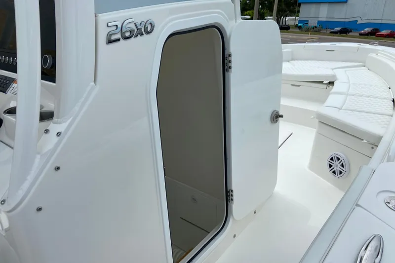 Slide: The Image of 2027 Regulator 26XO boat interior with open cabin door and cushioned seating. - 44
