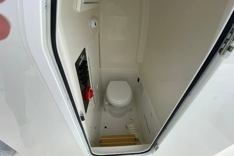 Slide: The Image of Interior of 2027 Regulator 26XO boat bathroom with toilet and control panel. - 45