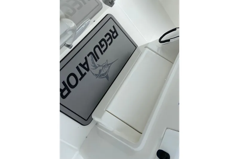 Slide: The Image of 2027 Regulator 26XO boat interior with branded mat and storage compartment. - 46