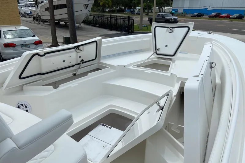 Slide: The Image of 2027 Regulator 26XO boat with open storage compartments and seating area. - 48