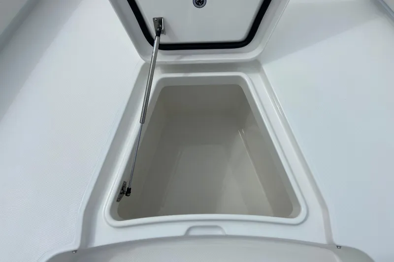 Slide: The Image of Open storage compartment on 2027 Regulator 26XO boat, showcasing interior space. - 55