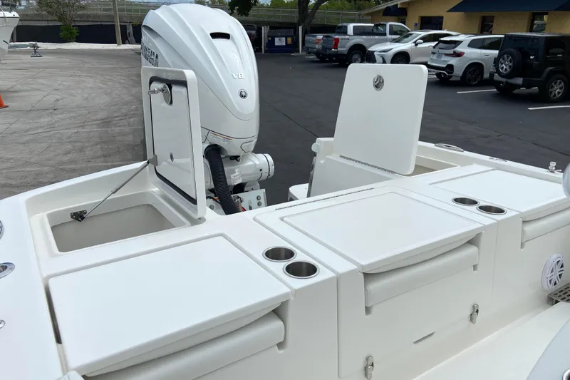 Slide: The Image of 2027 Regulator 26XO boat with open storage compartments and Yamaha V8 engine. - 6