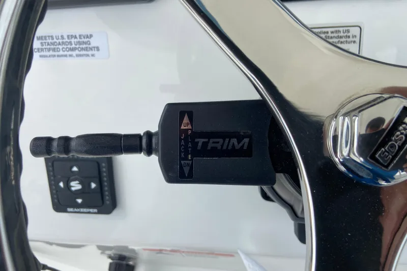Slide: The Image of Close-up of 2027 Regulator 26XO boat steering wheel and trim control. - 30