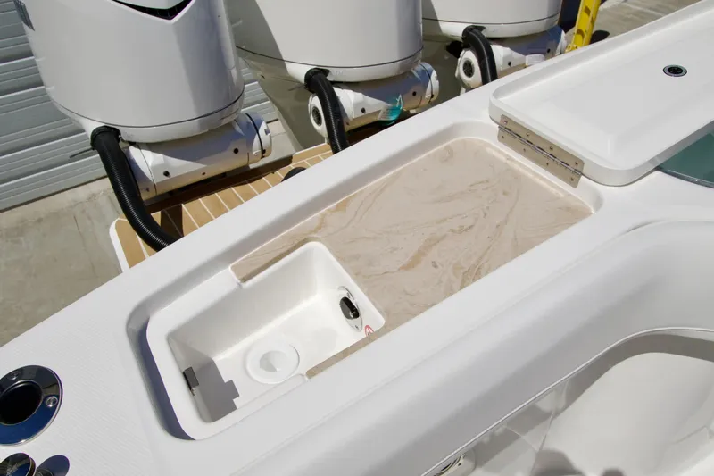 Slide: The Image of Regulator 35 boat interior with storage compartments and outboard motors, 2027 model. - 13