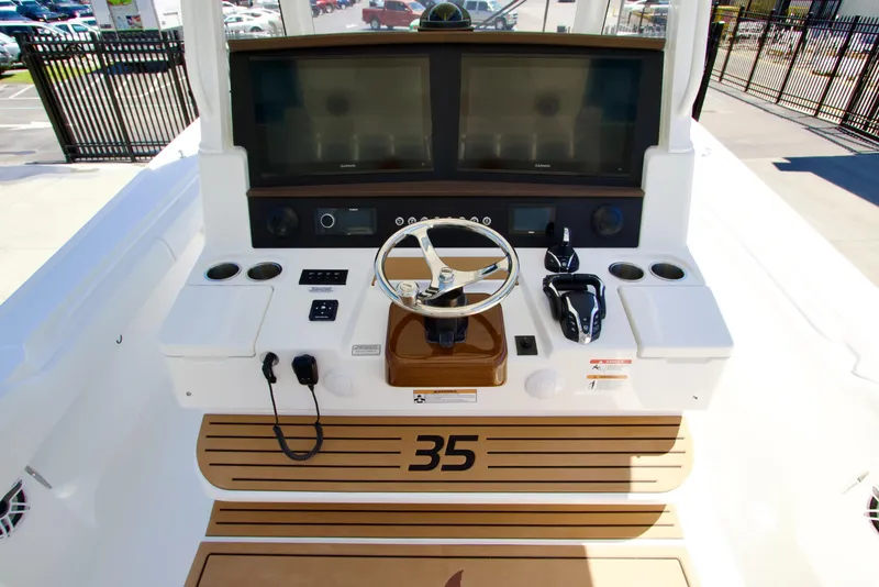 Slide: The Image of 2027 Regulator 35 boat helm with dual screens and steering wheel. - 16