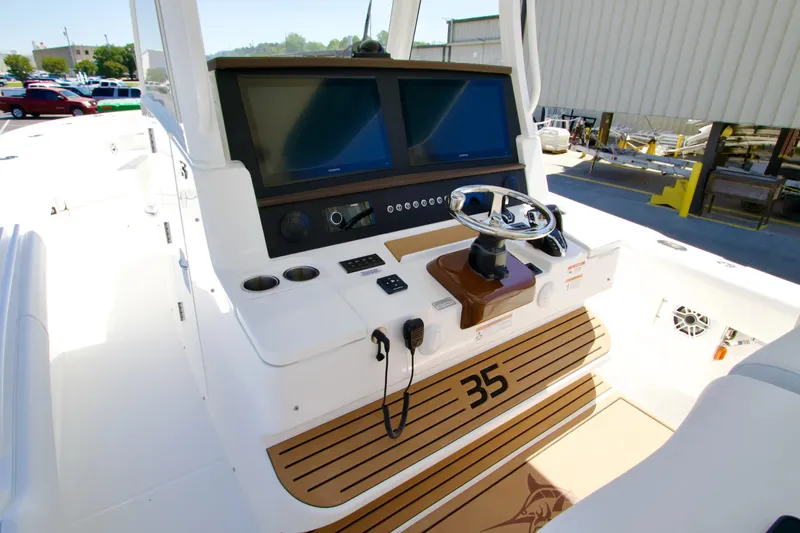 Slide: The Image of Helm of 2027 Regulator 35 boat with dual screens and modern controls. - 17