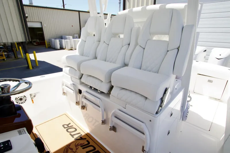 Slide: The Image of Luxury seating on 2027 Regulator 35 boat, featuring white cushioned captain chairs. - 23