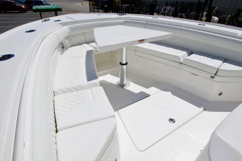 Slide: The Image of Luxurious seating area on a 2027 Regulator 35 boat, featuring white upholstery and a central table. - 25