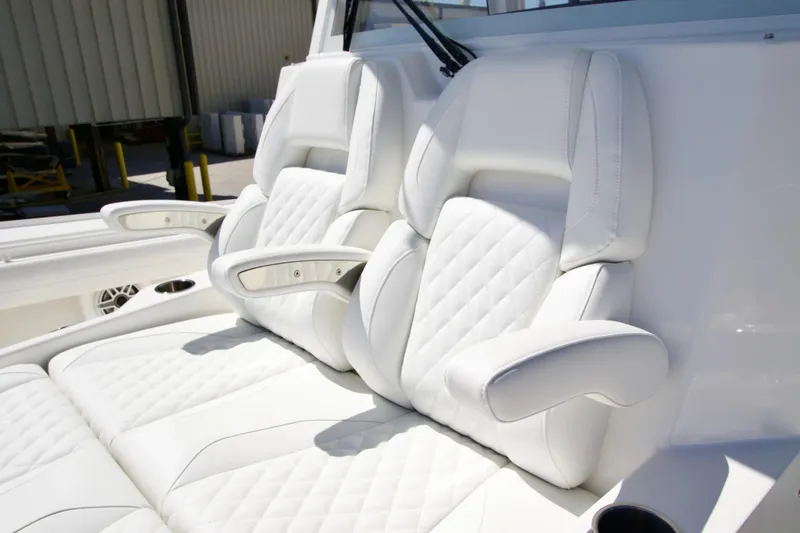 Slide: The Image of Luxurious white seating on 2027 Regulator 35 boat, featuring quilted design and armrests. - 29