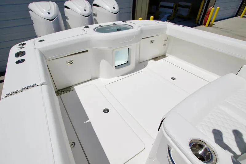 Slide: The Image of 2027 Regulator 35 boat deck with storage compartments and triple Yamaha engines. - 7