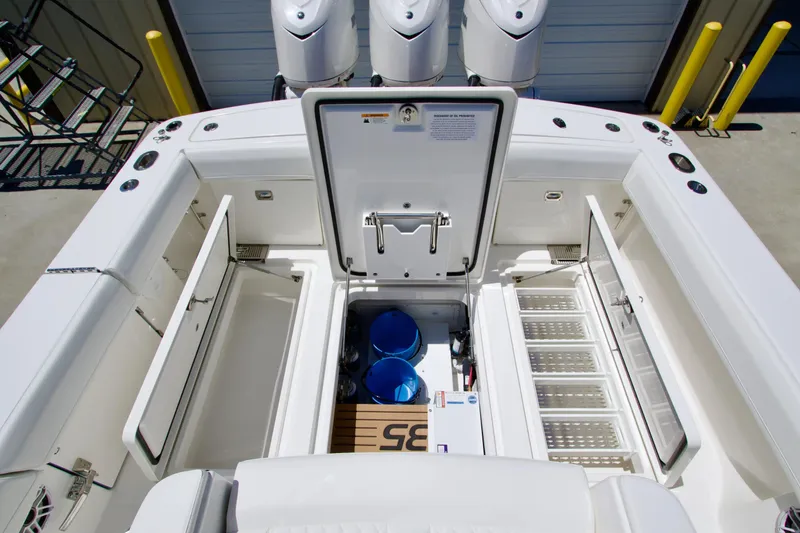 Slide: The Image of 2027 Regulator 35 boat interior with open storage compartments and visible engines. - 9