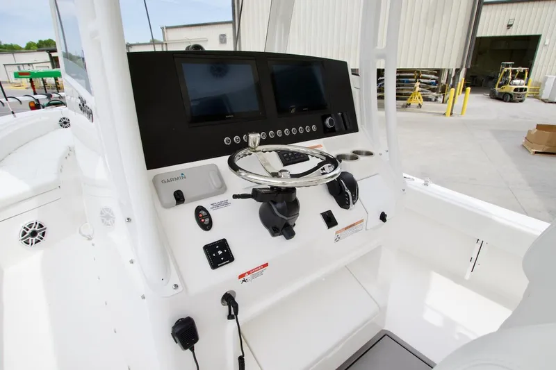 Slide: The Image of 2026 Regulator 26XO boat console with Garmin navigation and steering wheel. - 10