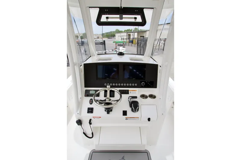 Slide: The Image of Helm of 2026 Regulator 26XO boat with modern controls and steering wheel. - 12
