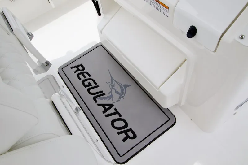 Slide: The Image of 2026 Regulator 26XO boat interior with branded mat and seating. - 13