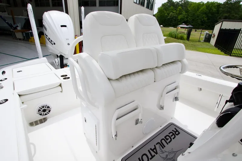 Slide: The Image of 2026 Regulator 26XO boat interior with white seating and Yamaha engine. - 14