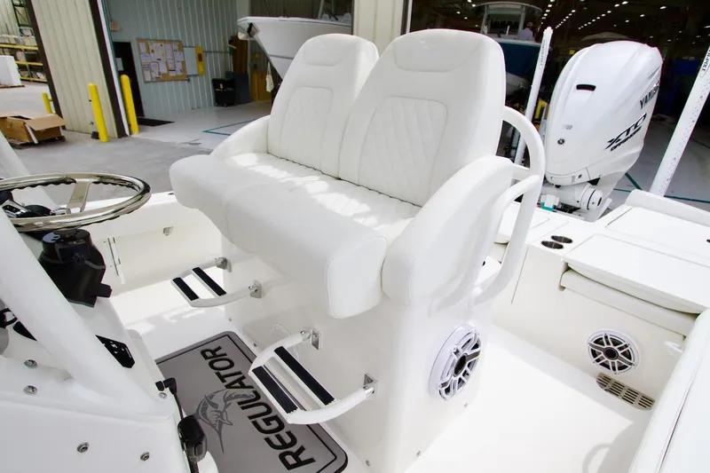 Slide: The Image of 2026 Regulator 26XO boat interior with white seating and Yamaha engine. - 15