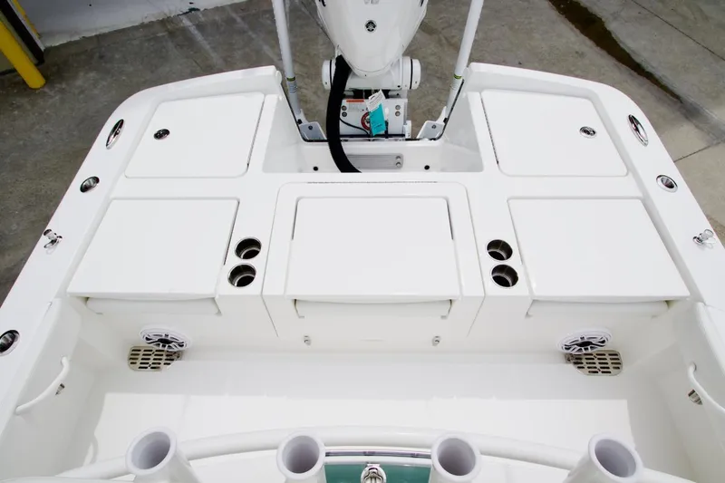 Slide: The Image of 2026 Regulator 26XO boat deck with storage compartments and rod holders. - 16