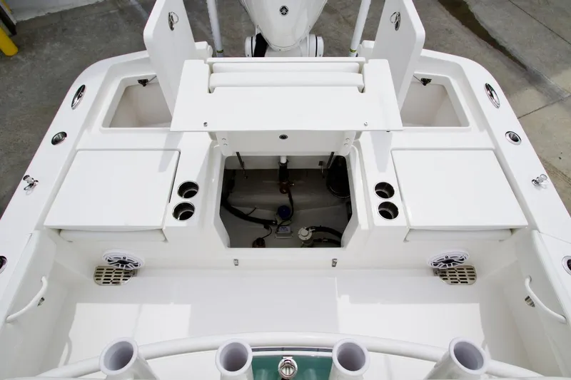 Slide: The Image of 2026 Regulator 26XO boat deck with storage compartments and rod holders. - 17