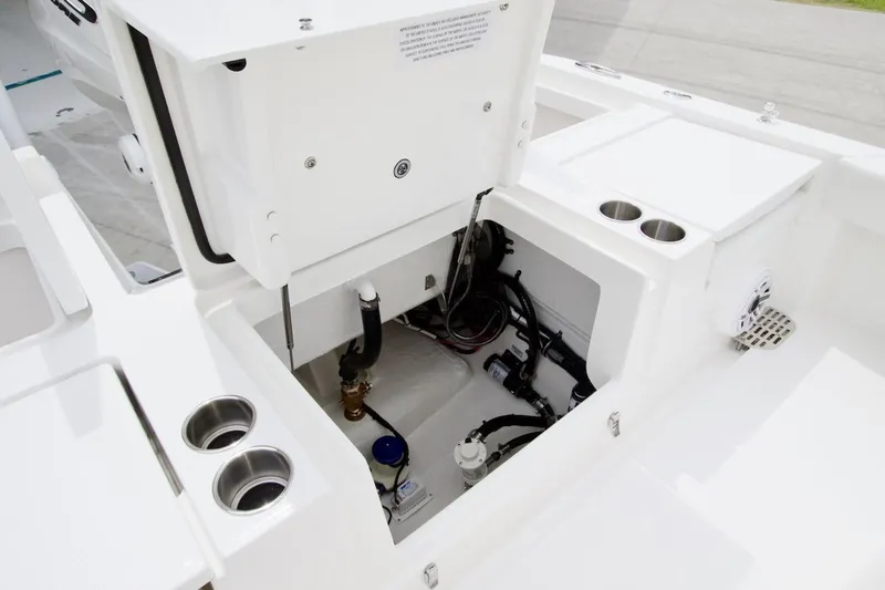 Slide: The Image of 2026 Regulator 26XO boat interior compartment with visible wiring and plumbing. - 18
