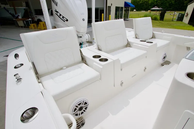 Slide: The Image of 2026 Regulator 26XO boat interior with white seating and Yamaha engine. - 19
