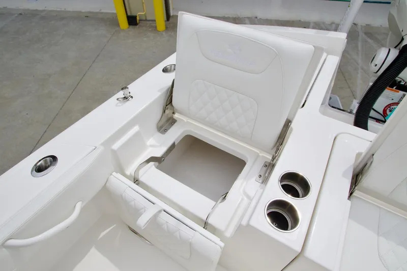 Slide: The Image of 2026 Regulator 26XO boat seat with storage and cup holders, featuring white upholstery. - 20