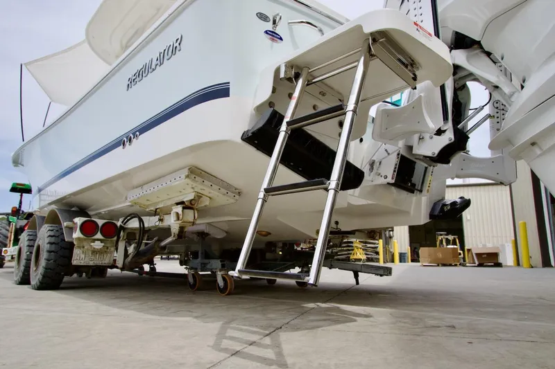 Slide: The Image of 2026 Regulator 26XO boat on trailer with ladder, viewed from rear. - 29