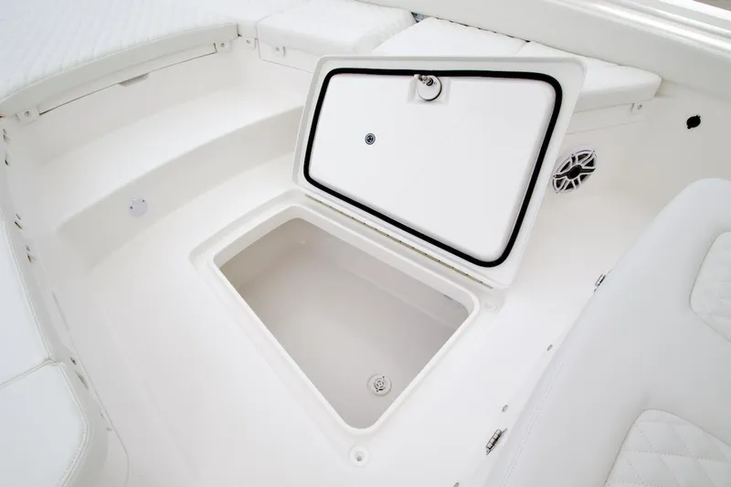Slide: The Image of Open storage compartment on 2026 Regulator 26XO boat, featuring white interior design. - 5