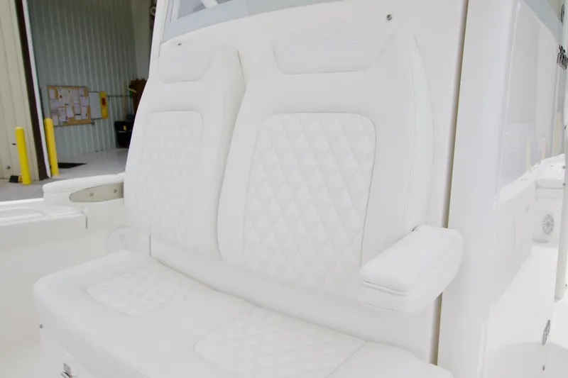 Slide: The Image of Luxurious white seating on 2026 Regulator 26XO boat, featuring diamond-pattern upholstery. - 8