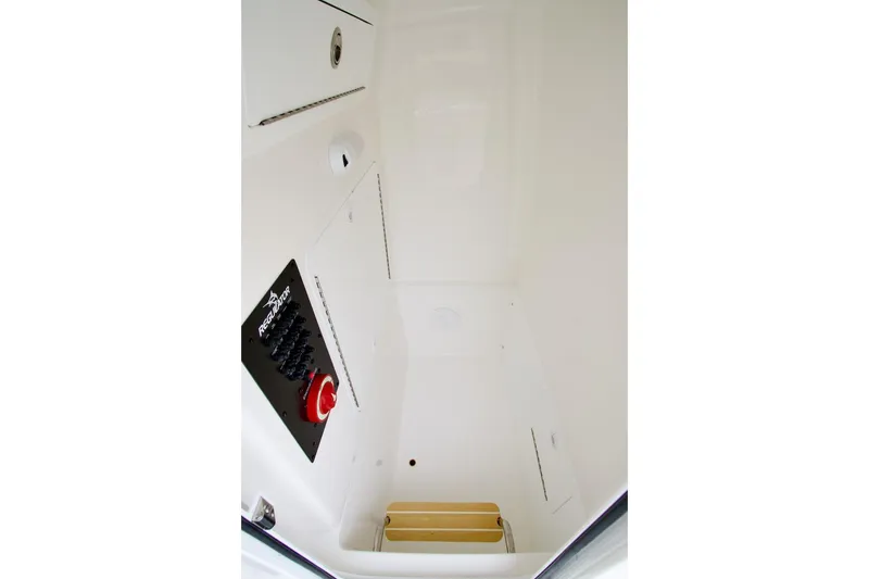 Slide: The Image of Interior view of 2026 Regulator 26XO boat compartment with control panel and storage. - 9