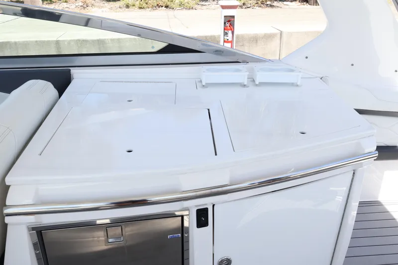 Slide: The Image of Luxury 2022 Regal 33 OBX boat interior with sleek white cabinetry and modern design. - 20