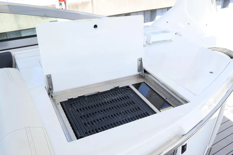 Slide: The Image of 2022 Regal 33 OBX boat with built-in grill on deck. - 21