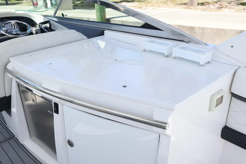 Slide: The Image of 2022 Regal 33 OBX boat interior with sleek white seating and modern dashboard. - 22