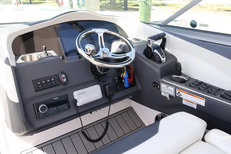 Slide: The Image of 2022 Regal 33 OBX boat dashboard with steering wheel and control panel. - 25