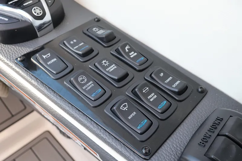 Slide: The Image of Control panel of a 2022 Regal 33 OBX boat with various function buttons. - 28