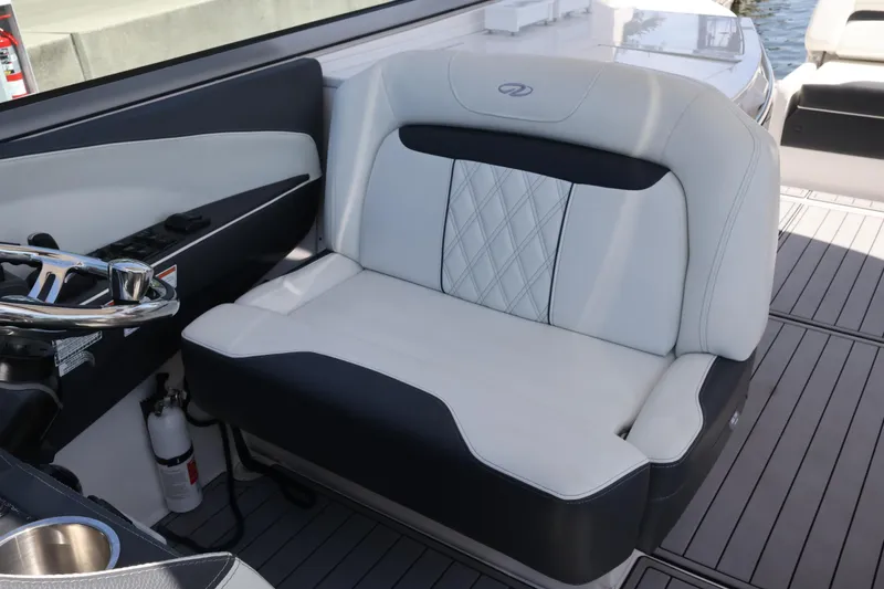 Slide: The Image of 2022 Regal 33 OBX boat interior with luxurious seating and modern steering wheel. - 31