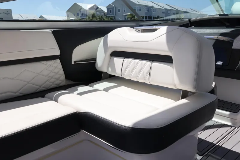 Slide: The Image of Luxurious seating in a 2022 Regal 33 OBX boat, featuring elegant white upholstery. - 32