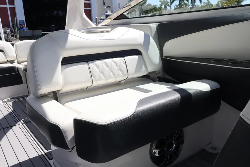 Slide: The Image of Luxurious seating on 2022 Regal 33 OBX boat, featuring elegant white and black upholstery. - 33