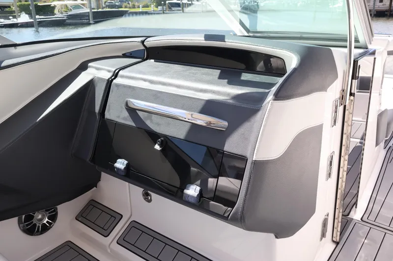 Slide: The Image of 2022 Regal 33 OBX boat interior with sleek dashboard and modern design. - 36
