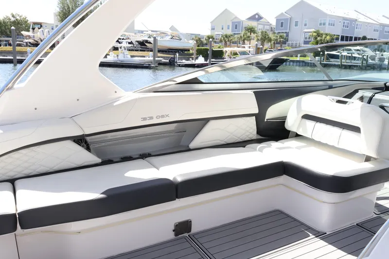 Slide: The Image of Manufacturer Provided Image: 2022 Regal 33 OBX boat bathroom with modern sink and wooden cabinetry. - 37