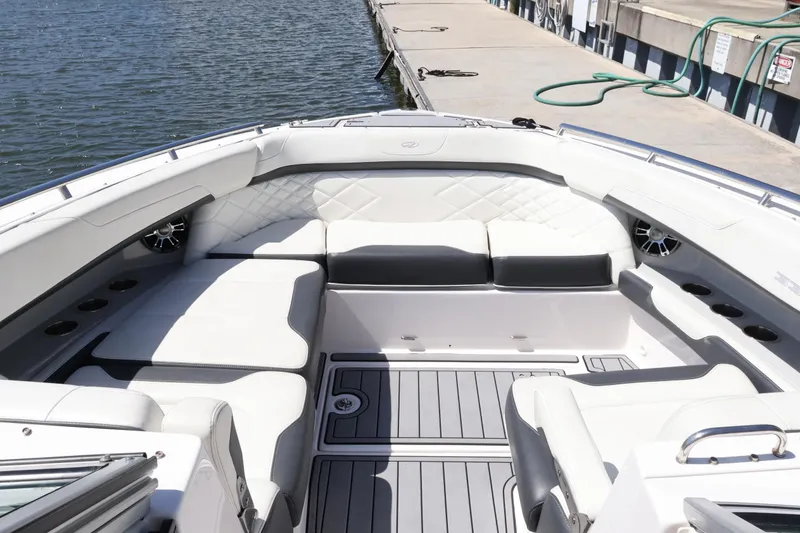 Slide: The Image of 2022 Regal 33 OBX boat interior with luxurious seating and modern design at dockside. - 38