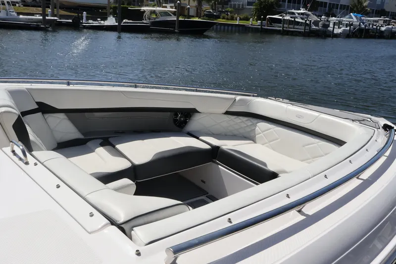 Slide: The Image of Luxurious seating area on a 2022 Regal 33 OBX boat by the water. - 39
