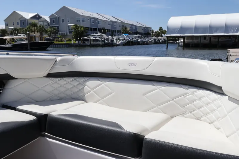 Slide: The Image of Luxurious seating on a 2022 Regal 33 OBX boat, docked near waterfront homes. - 41